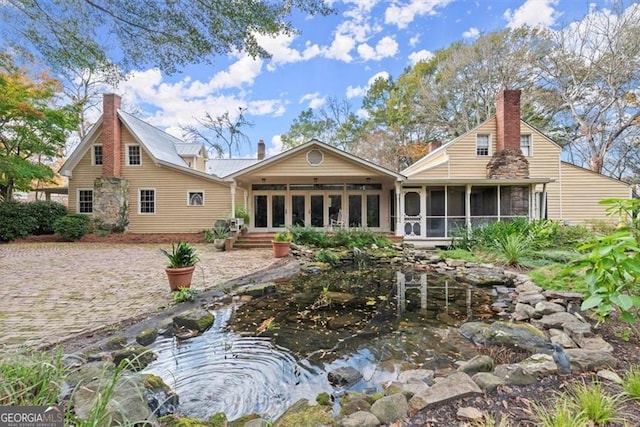 rear view of property with a sunroom