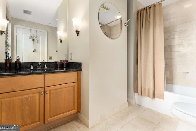 full bathroom featuring tile patterned flooring, vanity, toilet, and shower / bathtub combination with curtain