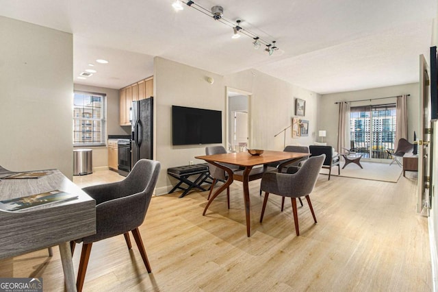 dining space with light wood-type flooring