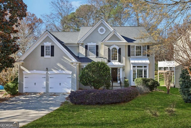 view of front of house featuring a front lawn and a garage