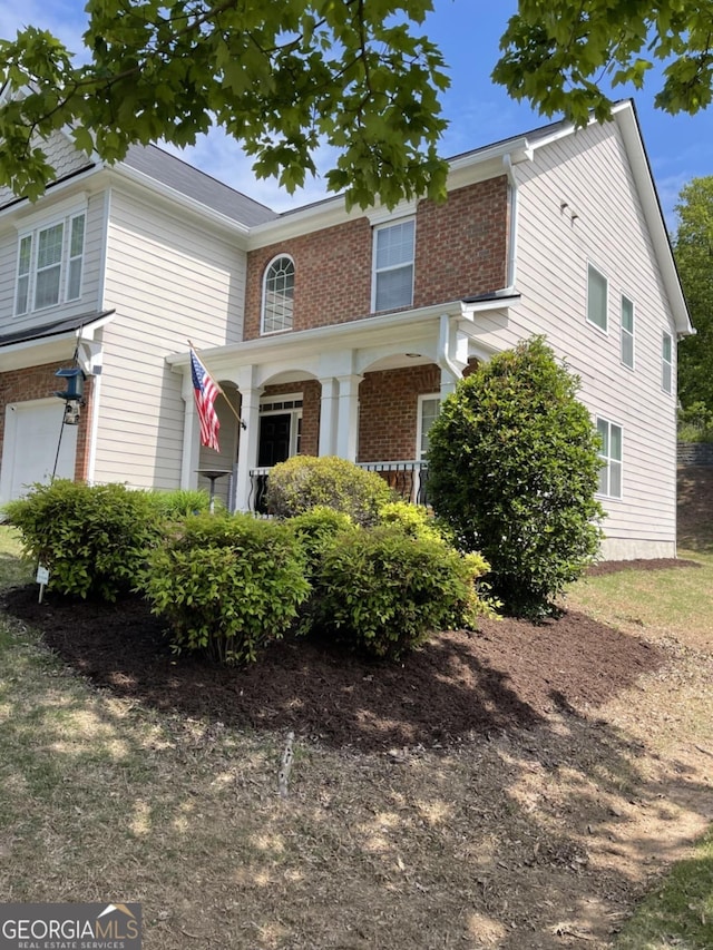 view of front of house with a porch and a garage