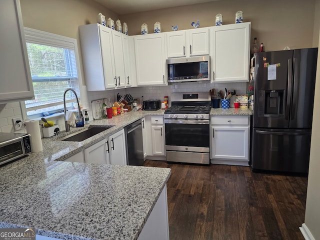 kitchen with a sink, backsplash, and stainless steel appliances