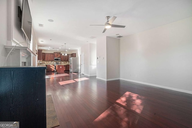 living room with ceiling fan and dark hardwood / wood-style floors