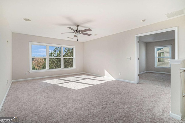 carpeted spare room with ceiling fan