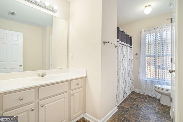 bathroom with vanity and toilet