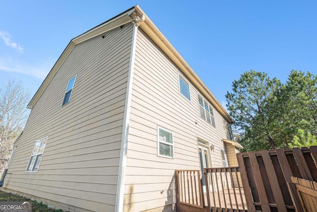 view of side of home with a wooden deck