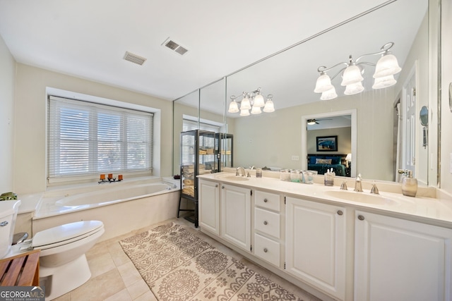 bathroom featuring vanity, tile patterned floors, a bathing tub, ceiling fan, and toilet