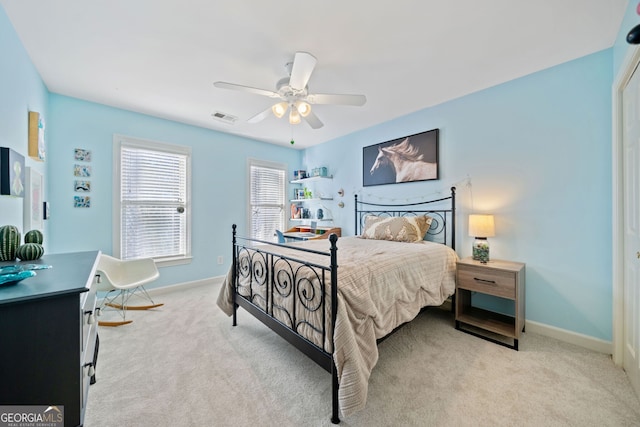 bedroom featuring light colored carpet and ceiling fan