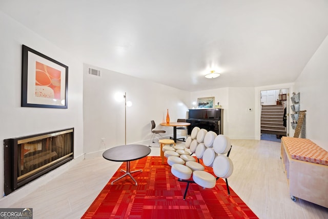 living room featuring a fireplace and wood-type flooring