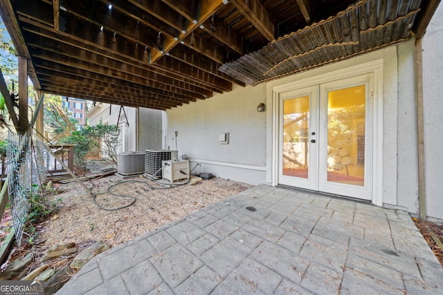 view of patio with french doors and cooling unit