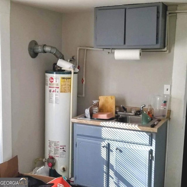 utility room with sink and water heater