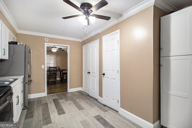 kitchen featuring white cabinets, electric range, ornamental molding, light hardwood / wood-style floors, and stainless steel refrigerator