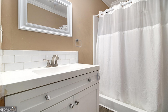 bathroom with decorative backsplash, vanity, and ornamental molding