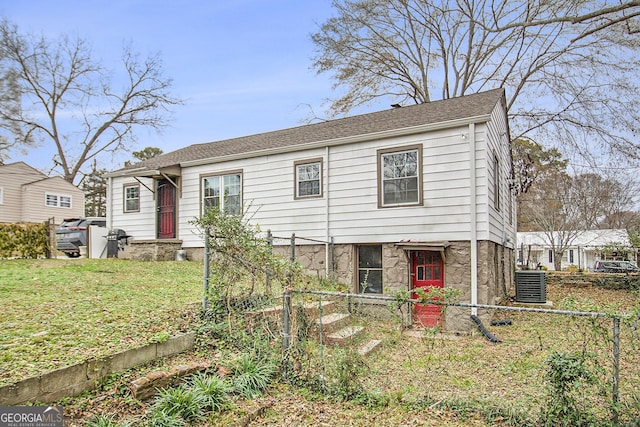 view of front of house with cooling unit and a front yard