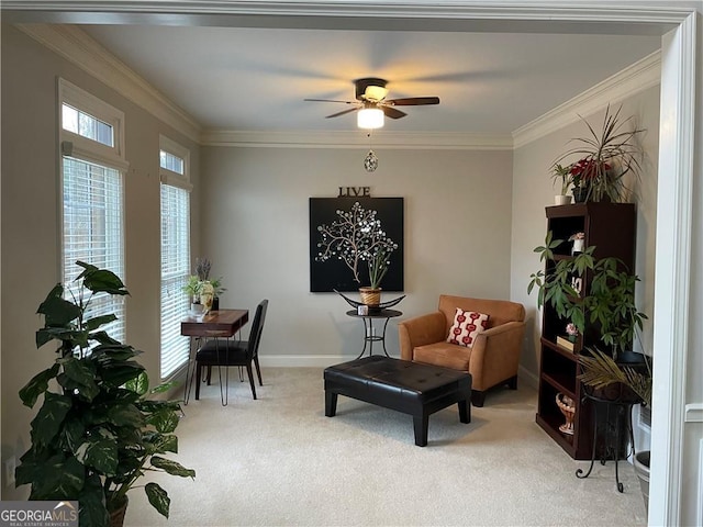 sitting room with ceiling fan, carpet floors, and crown molding