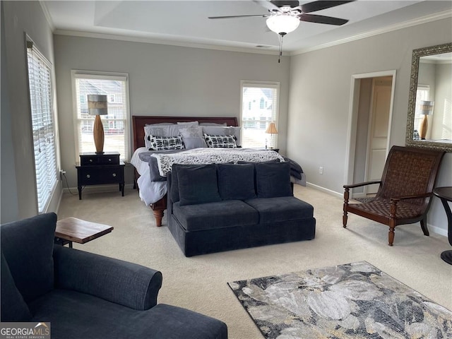 carpeted bedroom with ceiling fan, ornamental molding, and multiple windows