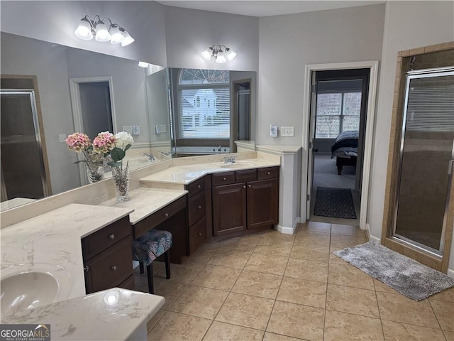 bathroom featuring tile patterned flooring, vanity, and walk in shower