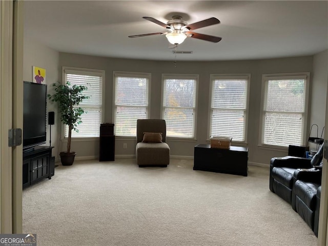 living room featuring ceiling fan and carpet floors