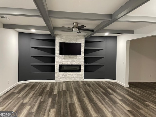 unfurnished living room featuring ceiling fan, dark hardwood / wood-style flooring, a fireplace, and built in shelves