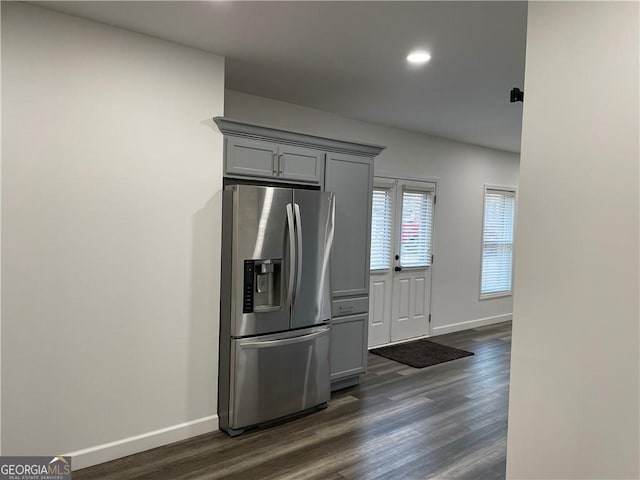 kitchen with dark hardwood / wood-style floors, gray cabinets, and stainless steel fridge with ice dispenser