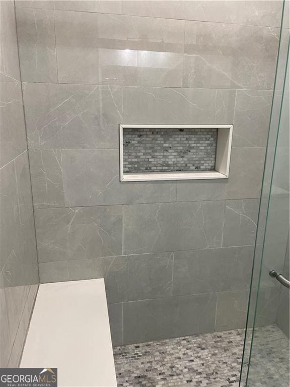 bathroom with a shower with shower door