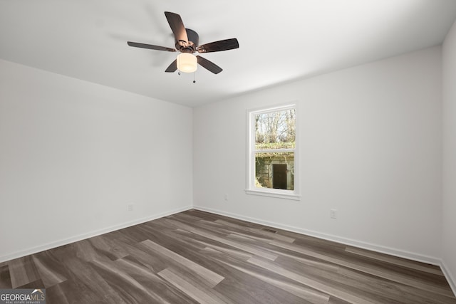 unfurnished room with ceiling fan and dark hardwood / wood-style floors