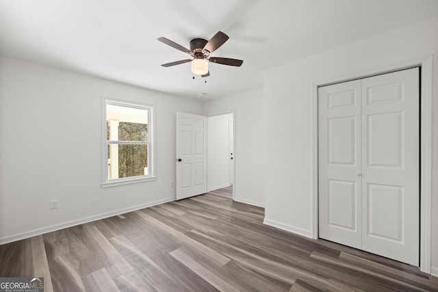 unfurnished bedroom featuring wood-type flooring, a closet, and ceiling fan