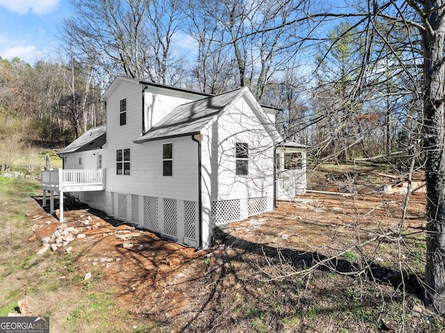 view of side of property featuring a wooden deck