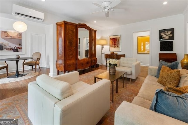 living room featuring light hardwood / wood-style floors, a wall mounted AC, crown molding, and ceiling fan