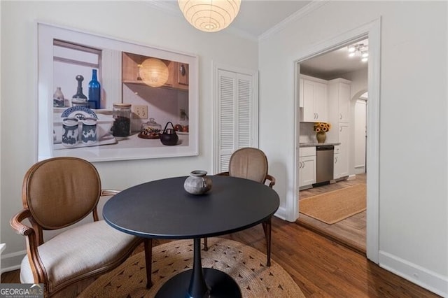 dining area featuring hardwood / wood-style floors and ornamental molding