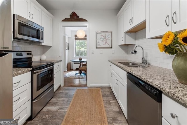 kitchen with white cabinets, sink, tasteful backsplash, dark hardwood / wood-style flooring, and stainless steel appliances