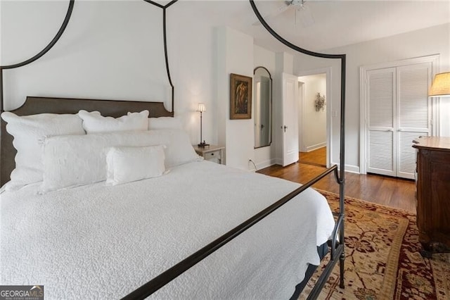 bedroom featuring dark hardwood / wood-style floors and a closet