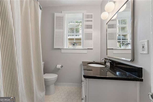 bathroom featuring vanity and toilet