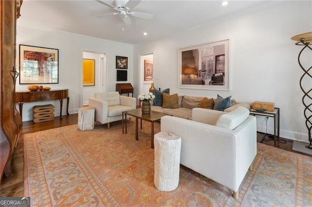 living room featuring hardwood / wood-style floors and ceiling fan