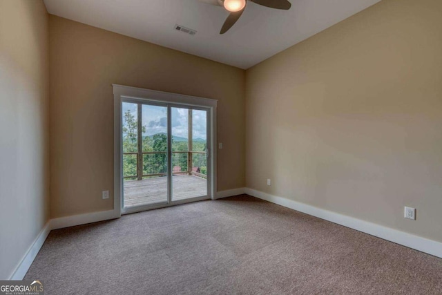 empty room featuring ceiling fan and carpet floors