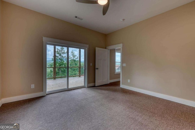 carpeted empty room featuring ceiling fan