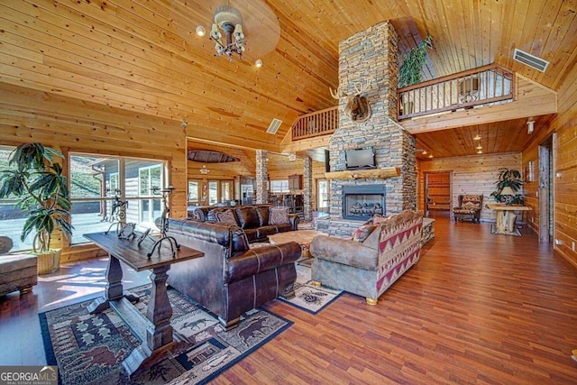 living room with hardwood / wood-style flooring, high vaulted ceiling, wooden ceiling, and wood walls