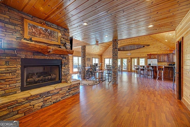 unfurnished living room with hardwood / wood-style floors, wooden ceiling, and a wealth of natural light