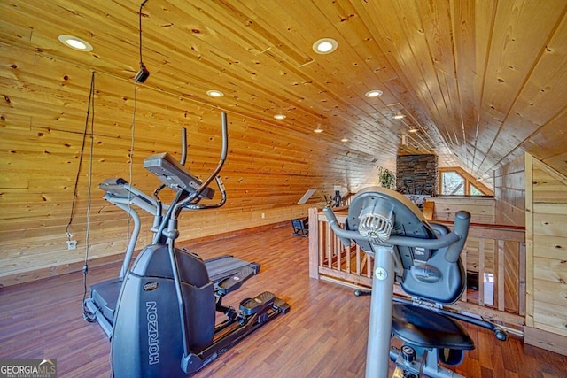 workout room with wooden walls, hardwood / wood-style floors, wood ceiling, and lofted ceiling