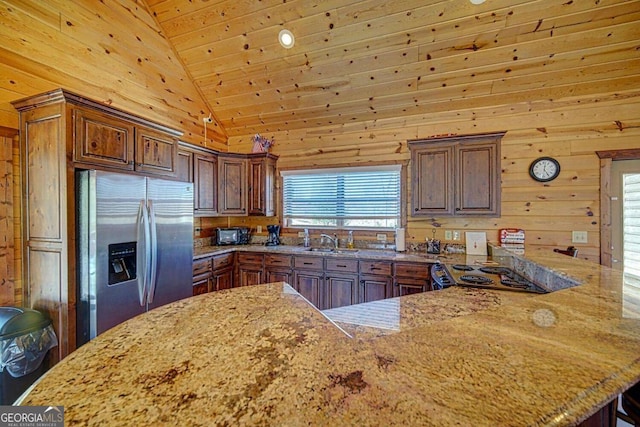 kitchen featuring wood walls, high vaulted ceiling, sink, stainless steel refrigerator with ice dispenser, and wood ceiling