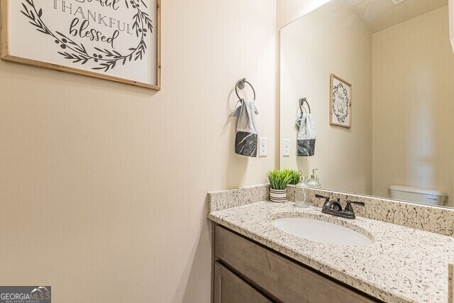 bathroom featuring vanity and toilet