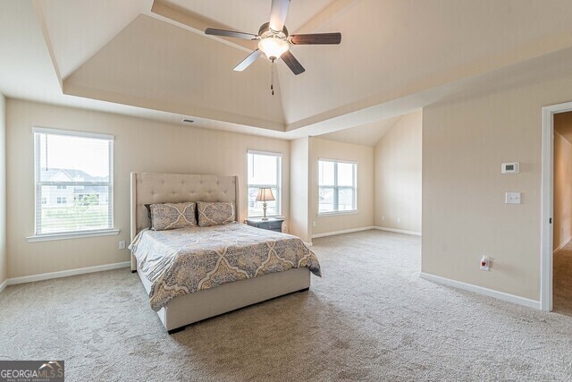 bedroom featuring ceiling fan, light carpet, and lofted ceiling