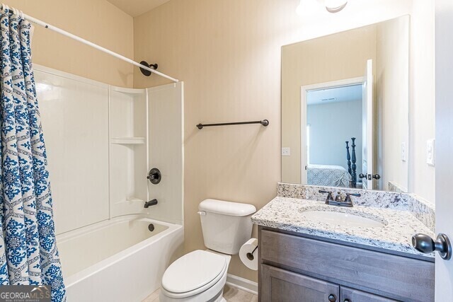 full bathroom featuring vanity, toilet, and shower / bath combo with shower curtain