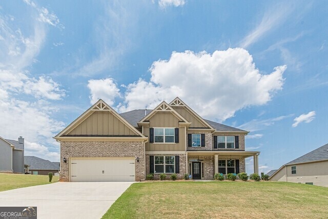 craftsman-style house with a front lawn and a garage