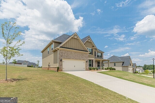 view of front of home with a garage and a front lawn