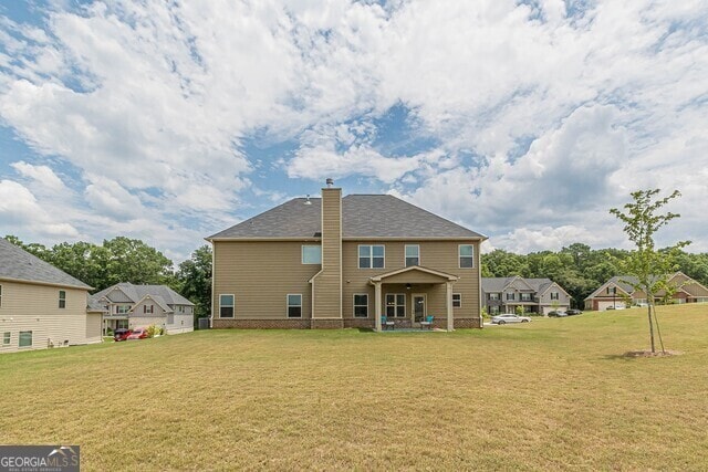 rear view of house with a lawn