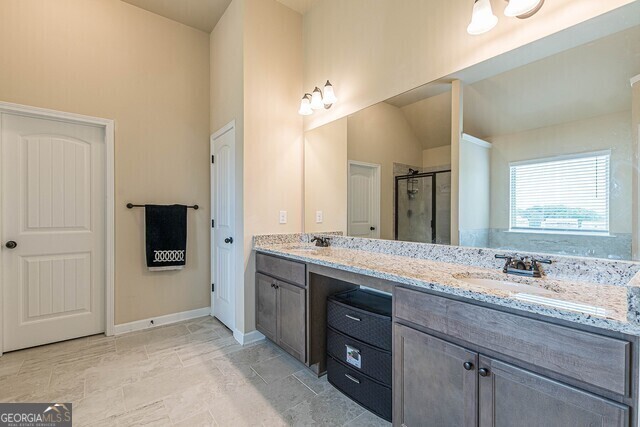 bathroom featuring vanity and an enclosed shower