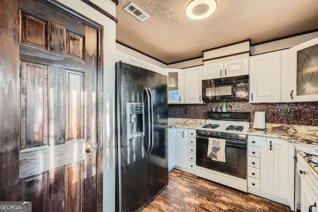 kitchen featuring light stone countertops, white cabinetry, dark wood-type flooring, a textured ceiling, and black appliances