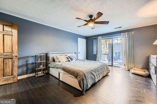 bedroom with ceiling fan, dark hardwood / wood-style floors, access to exterior, and a textured ceiling