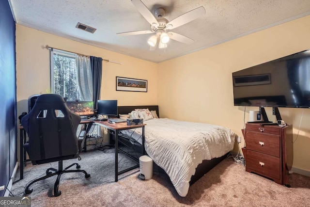 bedroom featuring ceiling fan, light colored carpet, ornamental molding, and a textured ceiling